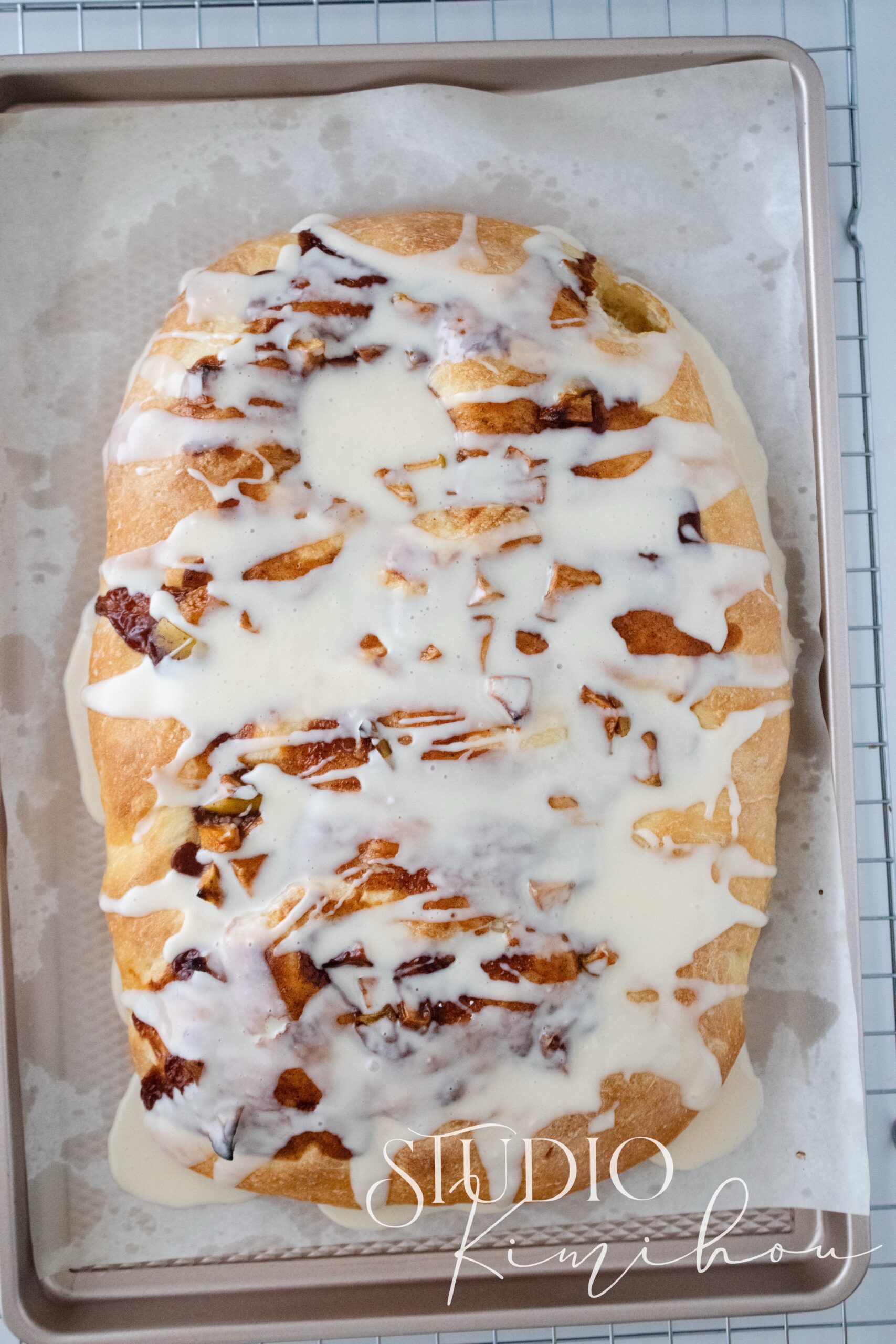 Apple fritter focaccia topped with cinnamon apples and vanilla glaze