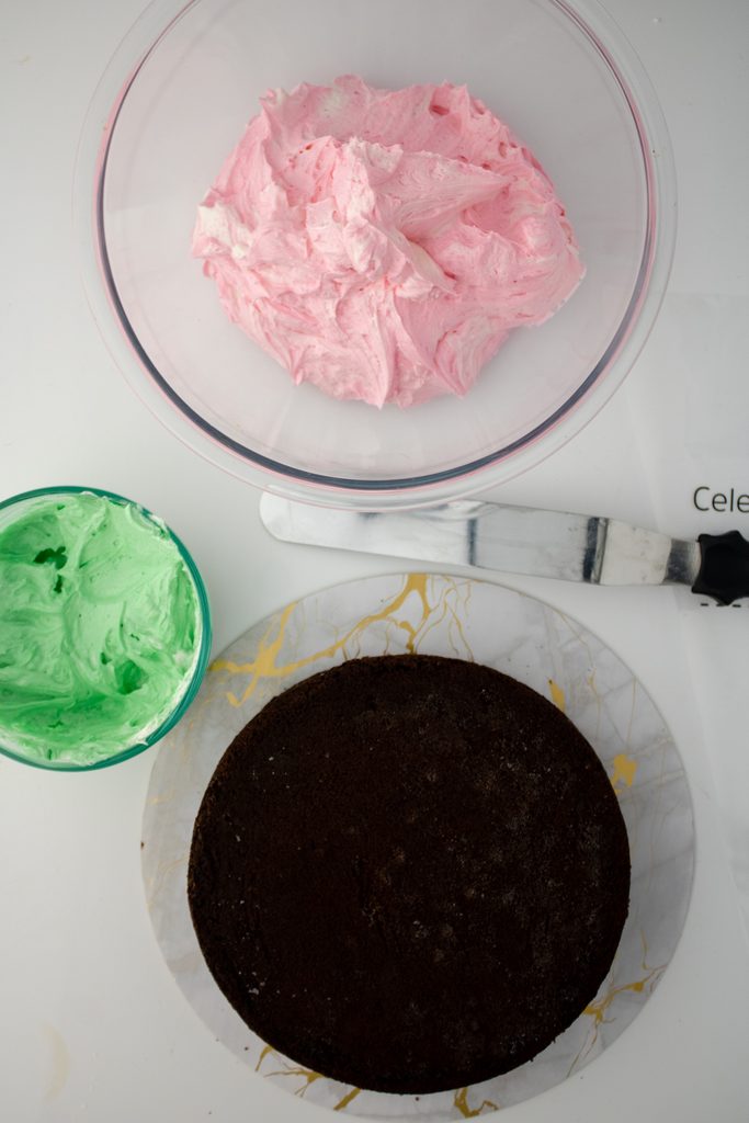 Pink and green buttercream prepared for decorating the birthday cake