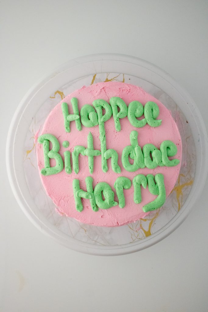 Green Happee Birthdae Harry message piped on pink frosting